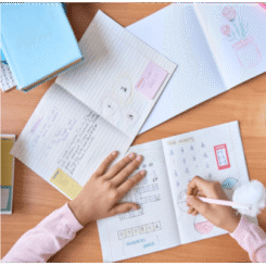study Child writing in a planner at Brain Booster, emphasizing academic responsibility and daily goal setting.